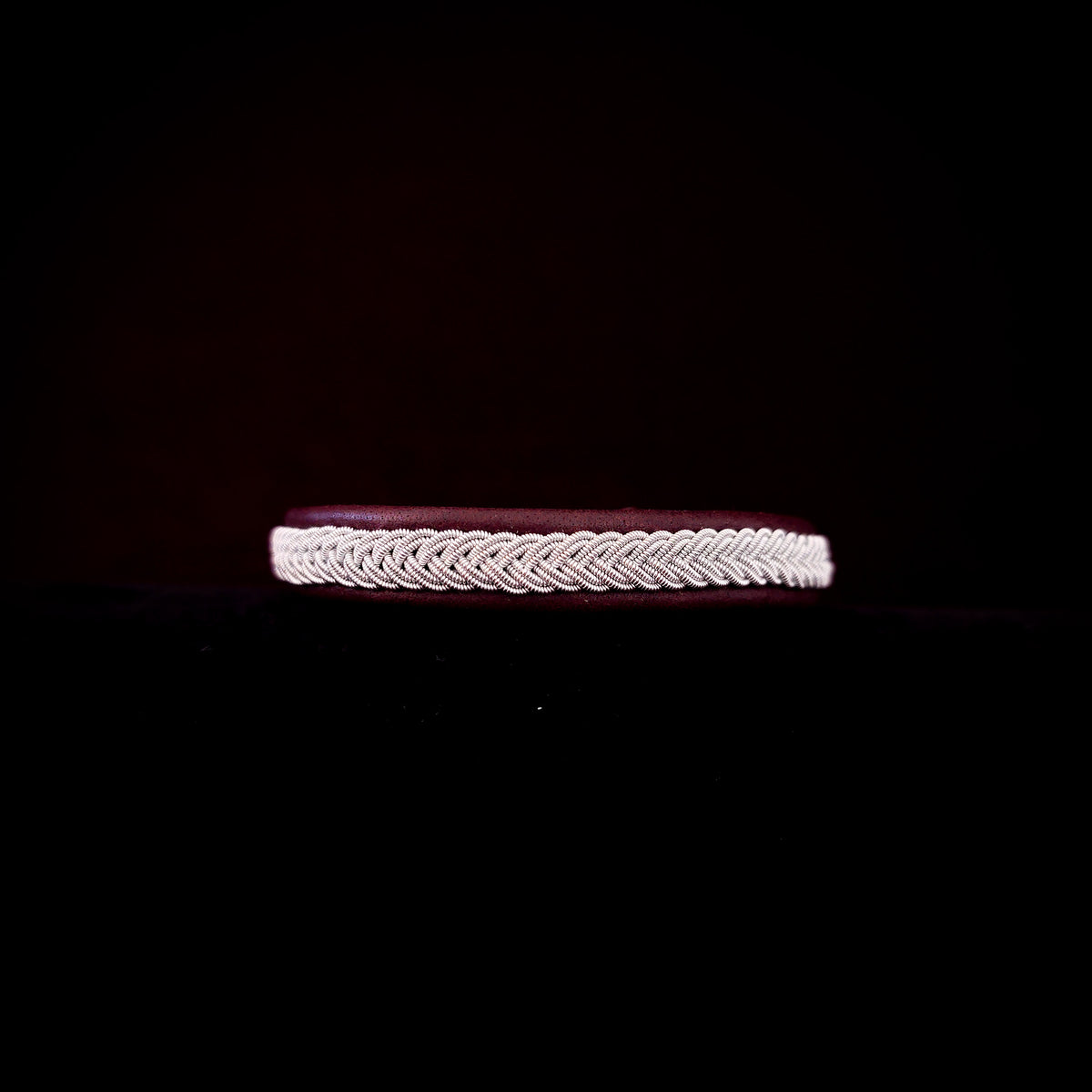 Bracelet with braided design on a black background