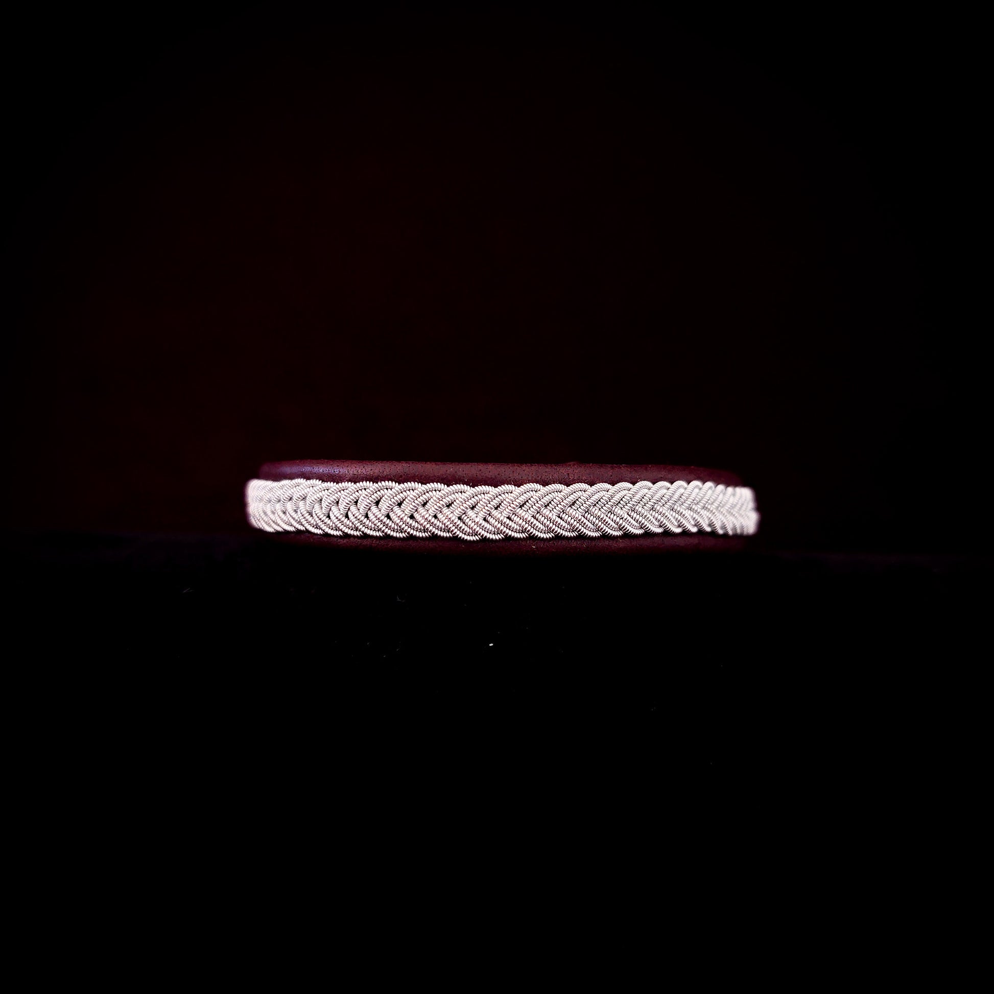 Bracelet with braided design on a black background