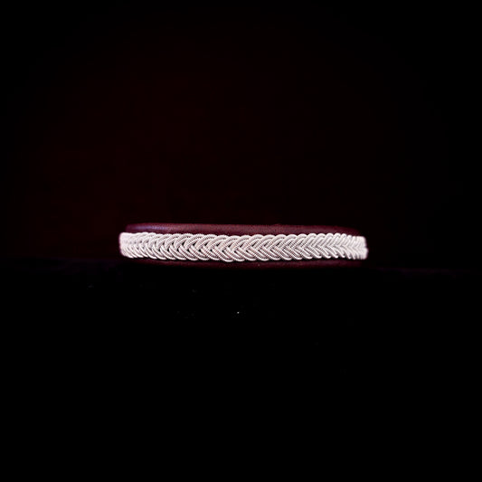 Bracelet with braided design on a black background